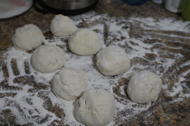 Rested green onion cake dough split into 8 individual balls. 