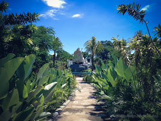 Garden Pathway Of The Park Between Plant Leaves In The Clear Blue Sky On A Sunny Day