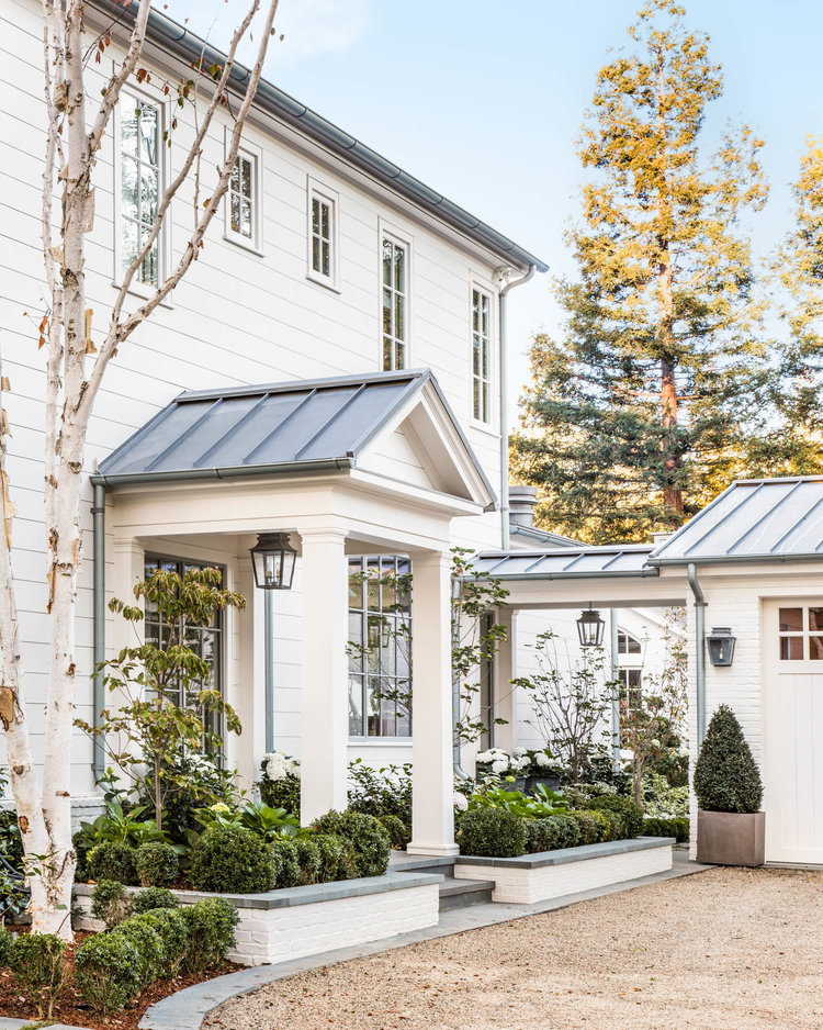 Beautiful modern farmhouse style home exterior with metal roof and white siding, Giannetti Home