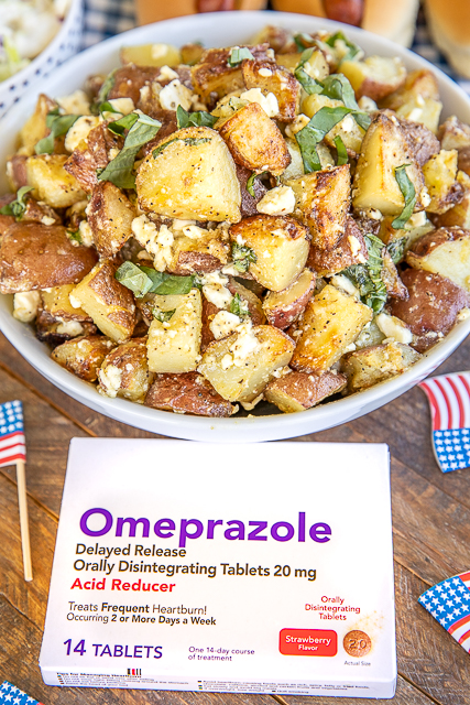 Grilled Greek Potato Salad Recipe - the BEST potato salad EVER! SO much amazing flavor! Grilled red potatoes tossed in feta, basil, olive oil, lemon juice, Greek seasoning, and mayonnaise. Can serve warm or cold. Great for potlucks - can make ahead of time and refrigerate overnight. I never have any leftovers! #grilled #bbq #sidedish #potatosalad grilled potato salad in a bowl with a box of omeprazole