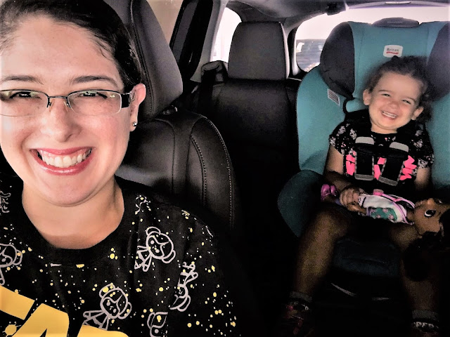 On our way to Supercon Me in the front seat, three-year-old in the backseat. We're all smiles.