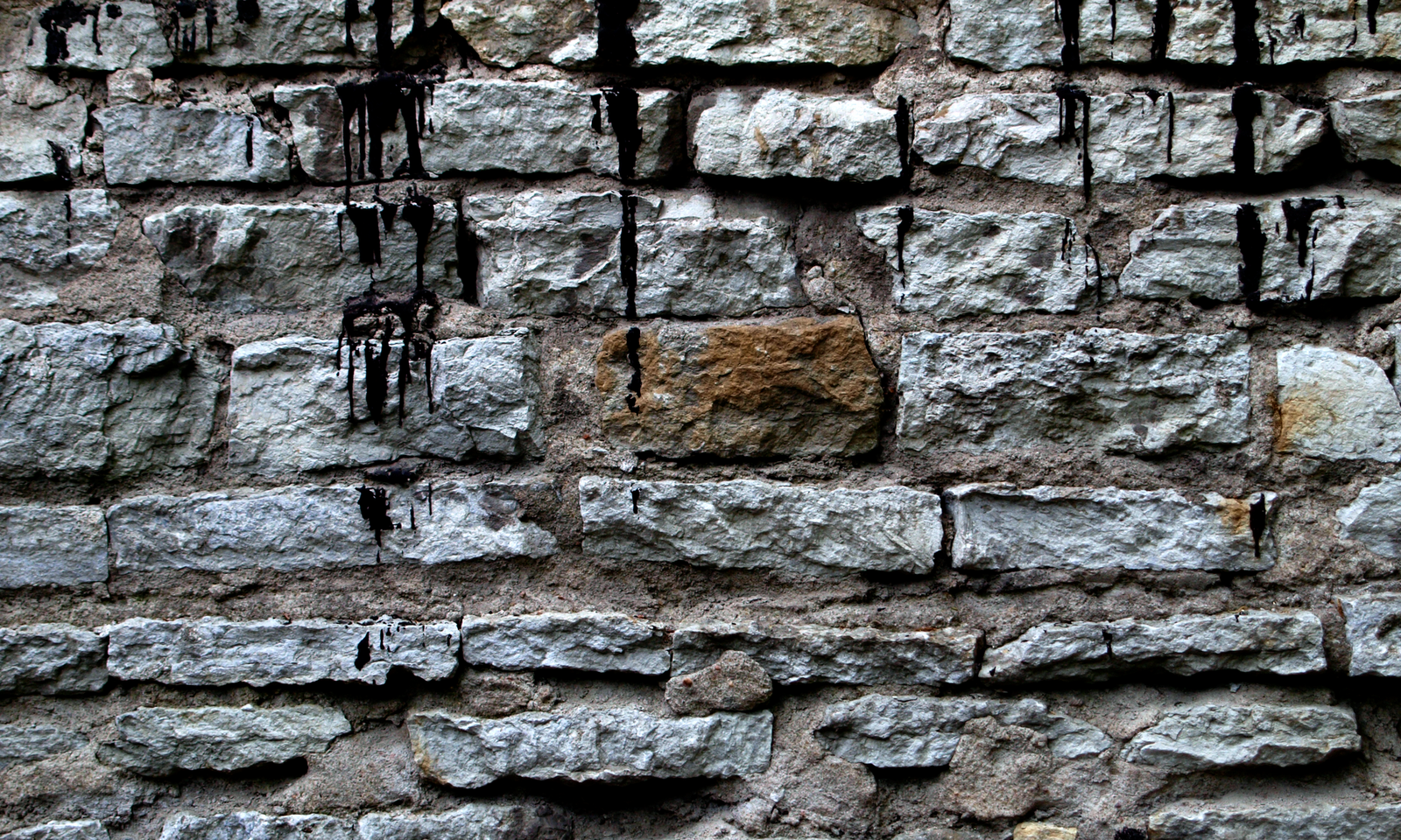 A Limestone Wall That Drools Black Paint (or tar) | ReUsage