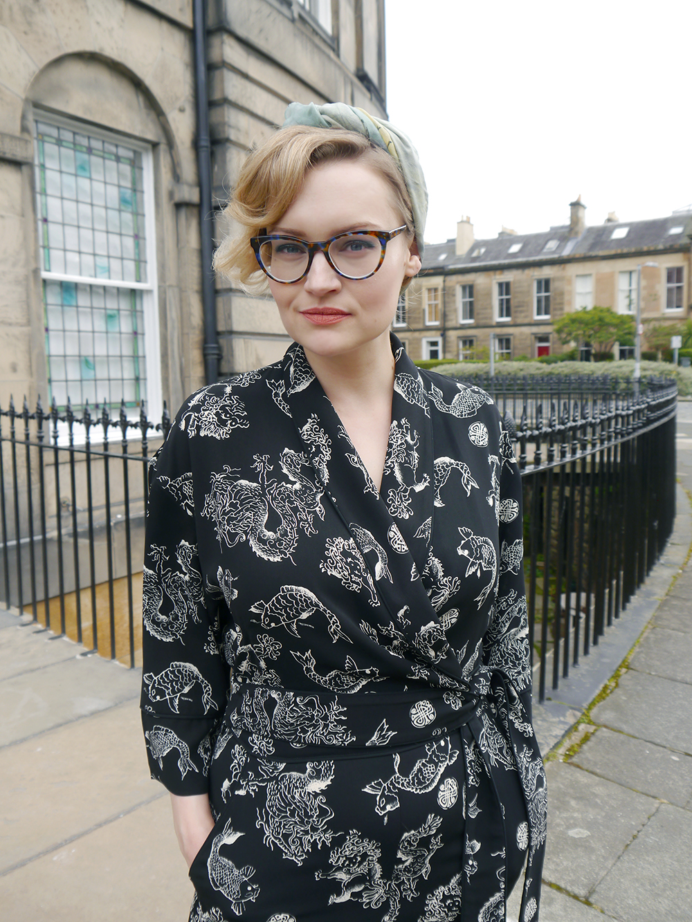 Chic streetwear with Scottish style blogger Kimberley from Wardrobe Conversations British fashion blogger Kimberley from Wardrobe Conversations wears a black print Biba jumpsuit, headscarf and CrossEyes glasses for an easy Sunday cocktail look