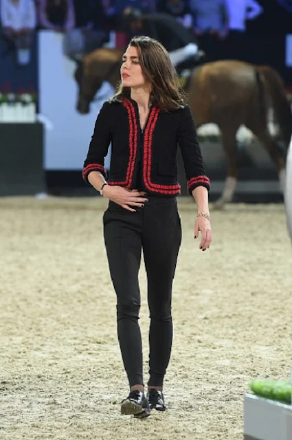 Charlotte Casiraghi  present the trophies to the GUCCI Gold Cup (CSI5) podium, winner Simon Delestre of France, second Patrice Delaveau of France  and third Maikel van der Vleuten of The Netherlands prior to the 'Style and Competition' show jumping charity event benefitting 'AMADE' on day three of the Longines Paris Masters 2015 held at the Paris-Nord Villepinte Exhibition Center