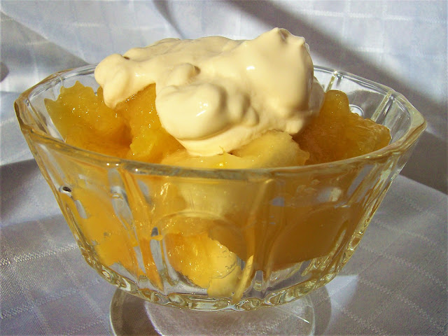 A serving of Orange Jelly Dessert topped with cream.