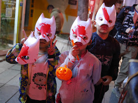 three children wearing Halloween masks in Changsha
