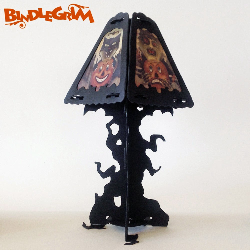 Lamp shade decoration on top of spooky tree silhouette from the Spooklights lighting series by artist Bindlegrim