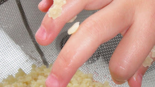 Baby hand digging through star pasta