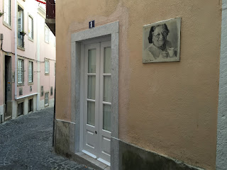 Street art in the Mouraria district by English photographer Camilla Watson - portraits of elderly residents printed on the walls of where they live