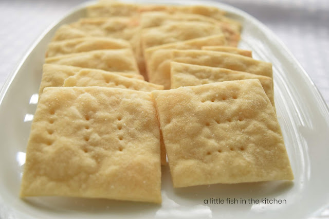 The fresh-baked crackers are presented on a white plate in two neat rows. They are ready to serve and enjoy!