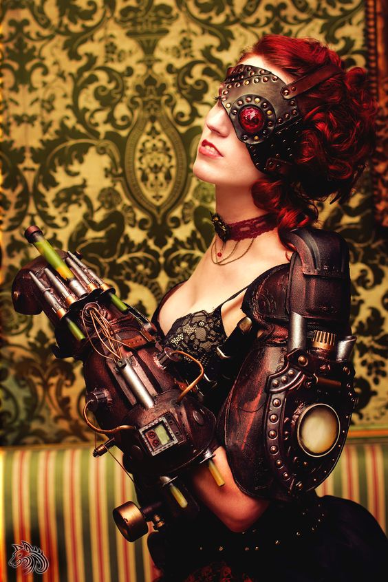 Steampunk woman with red hair wearing a lace bra with leather armor and gauntlet weapon