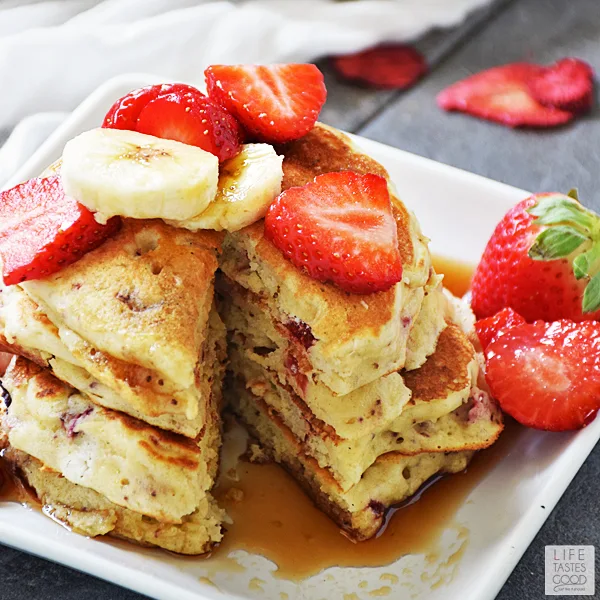 Strawberry Pancakes loaded with delicious dried strawberries and drizzled in maple syrup