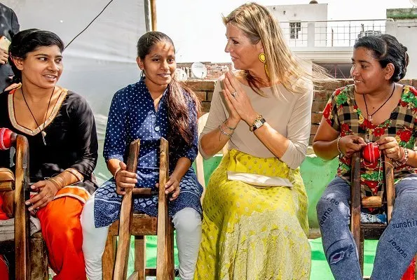 Queen Maxima visited a Cricket Factory, who got a loan from Aye Finance in Meerut in Uttar Pradesh. Queen wore Salvatore Ferragamo flat and earrings