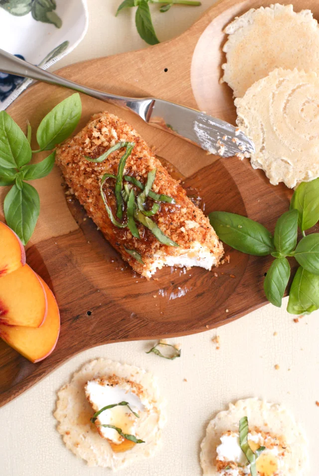 Honey, Basil, and Black Pepper Goat Cheese Spread is an easy to make, yet elegant appetizer made with fresh goat cheese that is rolled in pepper and panko then topped with a generous drizzle of honey and fresh basil.  It all comes together in just minutes! #BuzznBloom #sponsored @BuzznBloom
