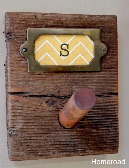 Brass accents on rustic peg hooks for the kitchen. 