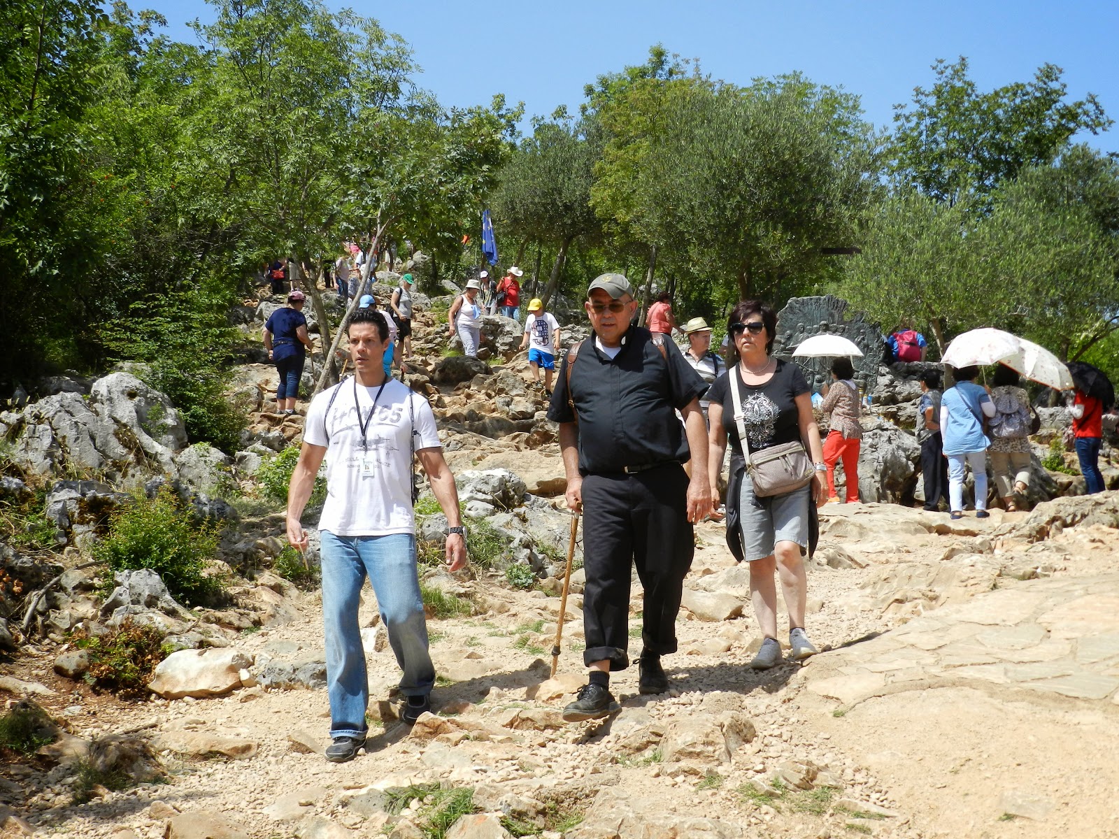 A photo of two fellow pilgrims completing the climb of Cross Mountain.