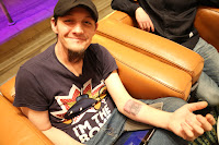 photo of tim cannon -founder of grid house wetware showing a chip under his skin on his left forearm.