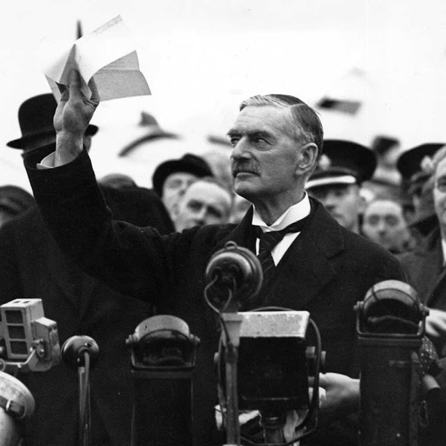British prime minister Neville Chamberlain displaying the Anglo-German Declaration to the crowd at the Heston Aerodrome on September 30, 1938. Later that day, in front of 10 Downing Street, he would declare "I believe it is peace for our time." Within a year Britain would be engulfed in World War II.