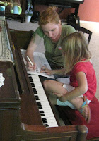 picture of Arianna Fourt teaching piano to young student