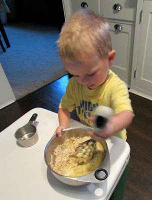 little guy mixing up a bowl of muffin batter