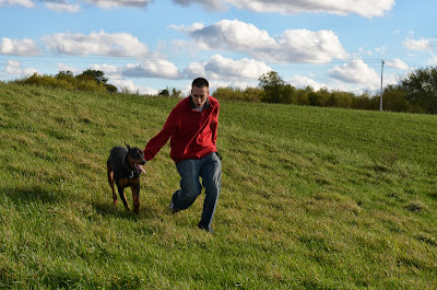 Onyx and Kurt run in the hayfield Photo by Trisha Field