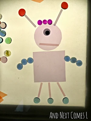 A robot made from loose parts on the light table from And Next Comes L