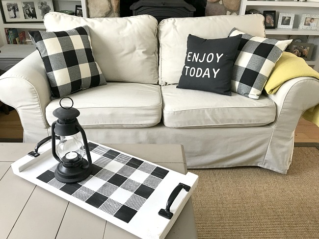 white couch with buffalo check accessories