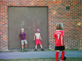 kids playing football against a wall football training brick wall and double doors