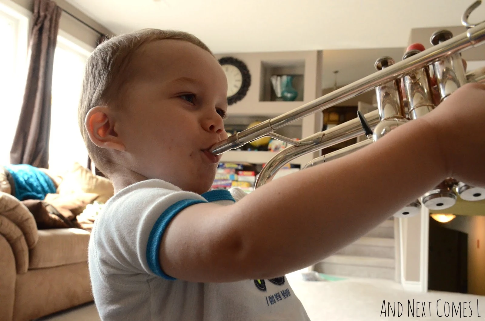 K playing the trumpet from And Next Comes L