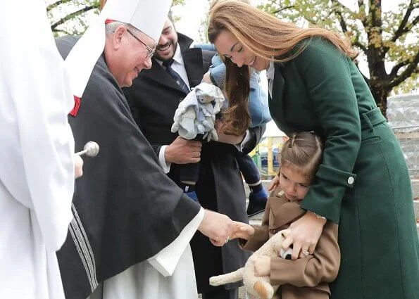 Prince Felix, Princess Claire and their children Princess Amalia and Prince Liam. Maria Teresa. Claire worn a green wool trench coat