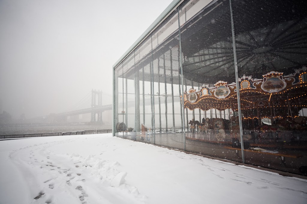 The Dumbo Carousel in it's glass case is a beautiful place to view the snowstorm from, Dumbo, New York