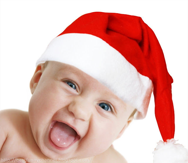 Laughing baby in Christmas cap.