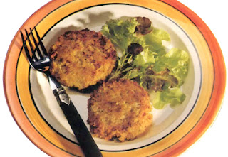 Curried vegetable burgers: potato-based vegetable patties flavoured with curry powder and fried until golden served with a salad