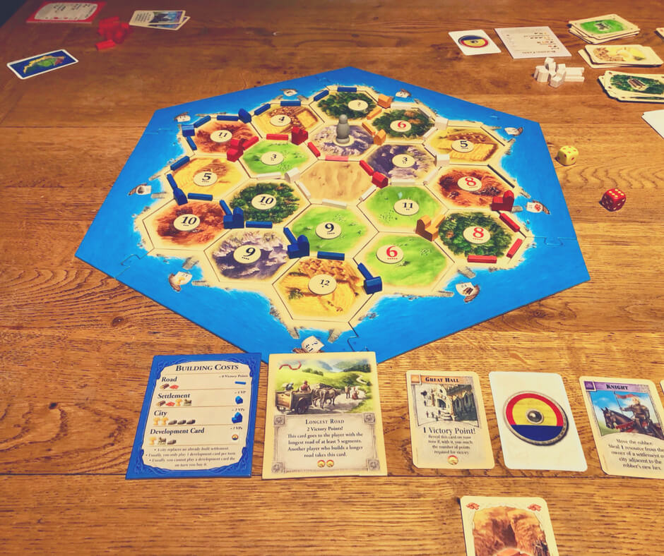 Catan, the board game, has been played. The game board is set out and the houses and roads are set up on the board.