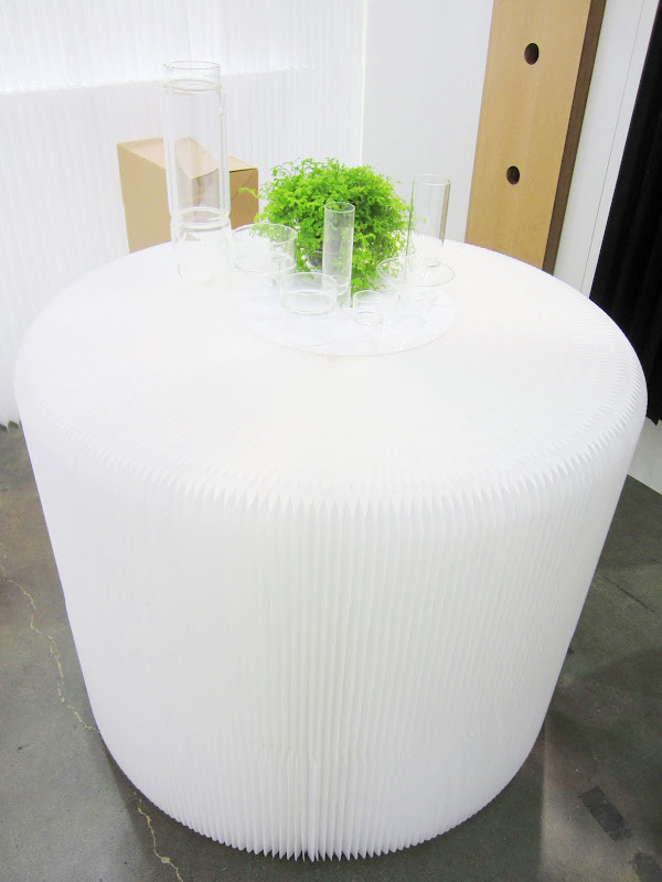 Two Softseating White Textile Fanning Stools stacked on top of each other to make a table