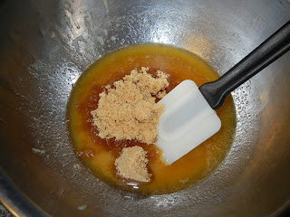 butter and brown sugar in a metal bowl with a rubber spatula 