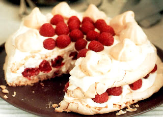 Meringue Layer Cake with Raspberries: Classic dessert cake of meringue layers separated with cream and raspberries