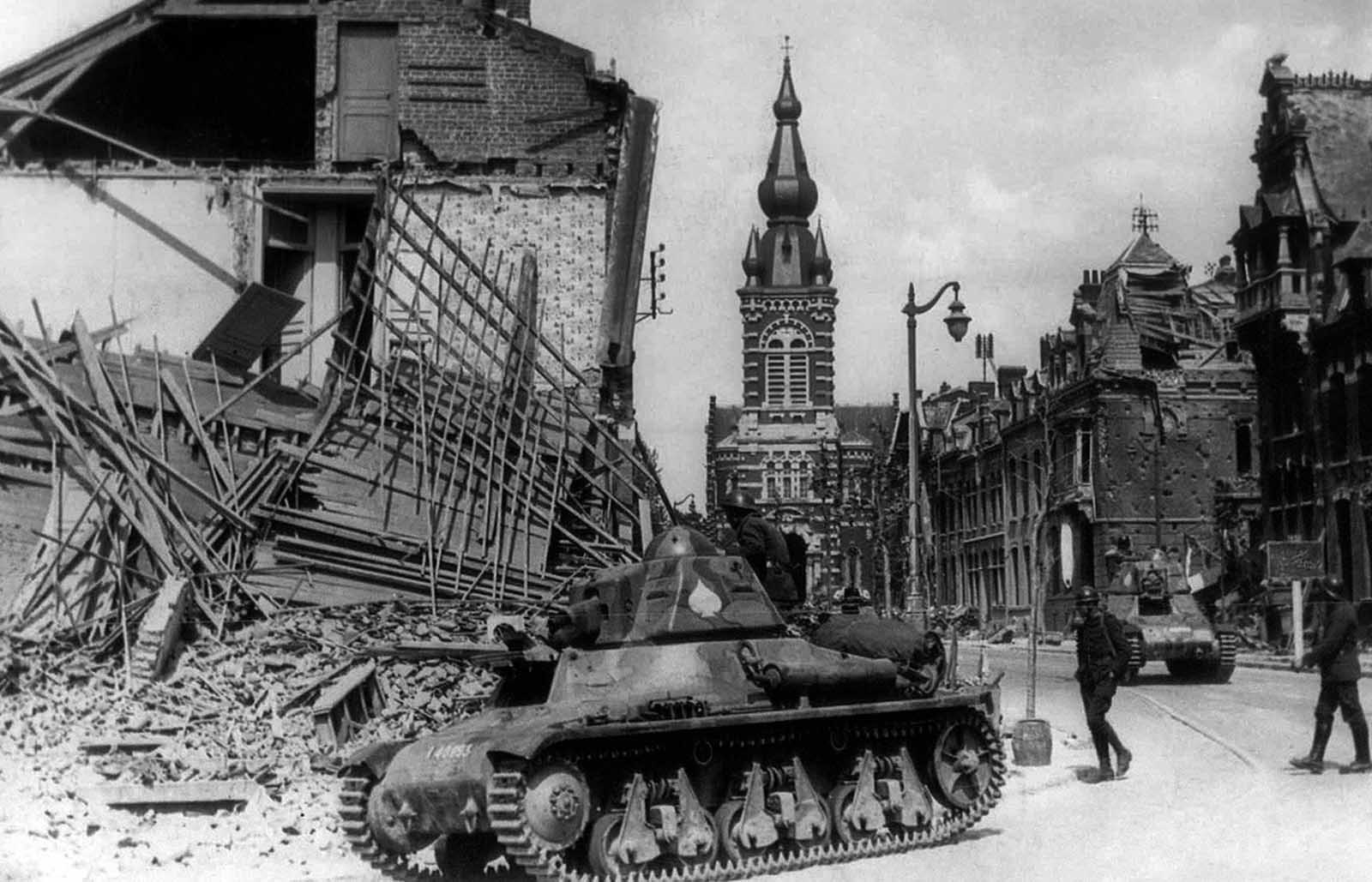 French tanks pass through a bombarded French town on their way to the front line in France, on May 25, 1940.