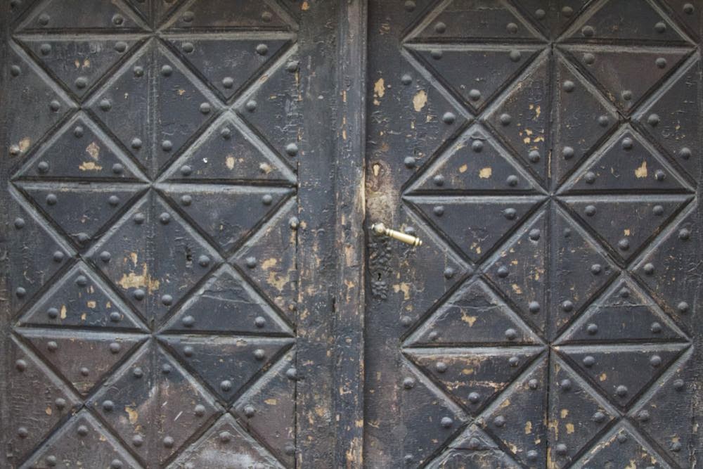 dark wooden door with rectangles and triangles
