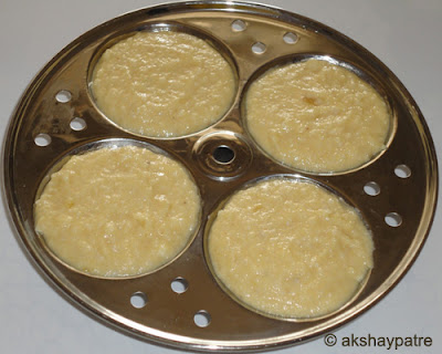 grease the idli plate and pour batter to make idly