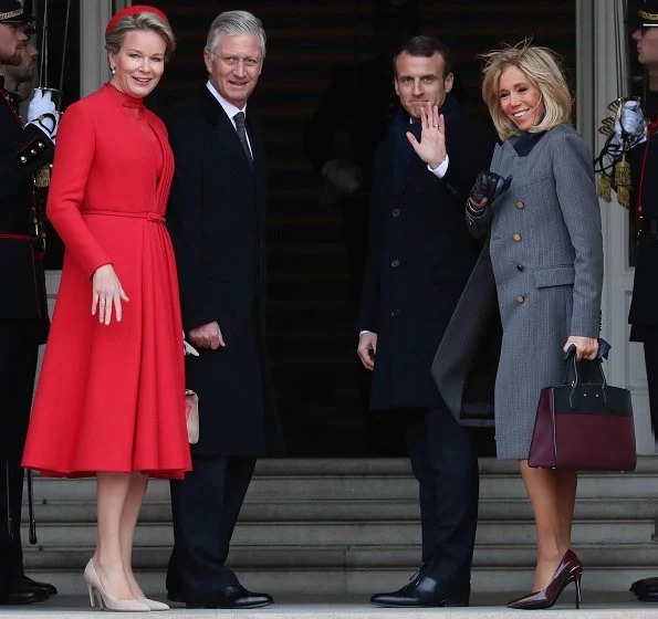 Queen Mathilde wearing a Christian Dior couture coat dress. Brigitte Macron wore Ralph Louren coat, dress and pumps
