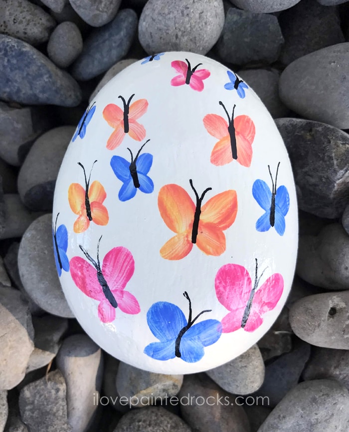 Watercolor butterfly rock painting ideas. I love this for garden art. This same technique would look great on stepping stones, too. #rockpainting #PaintedRockIdeas #paintedrocks #paintrock #paintedstone #rockart #stoneart #paintedstoneideas #ilovepaintedrocks #crafts #rockcrafts