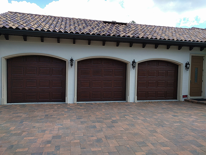 Three Oversized Single Garage Doors With Curved Top Painted To
