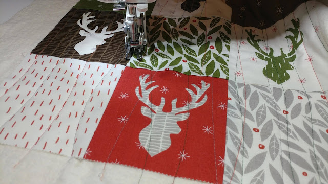 Christmas deer quilt using Merrily by Moda and Aurifil thread
