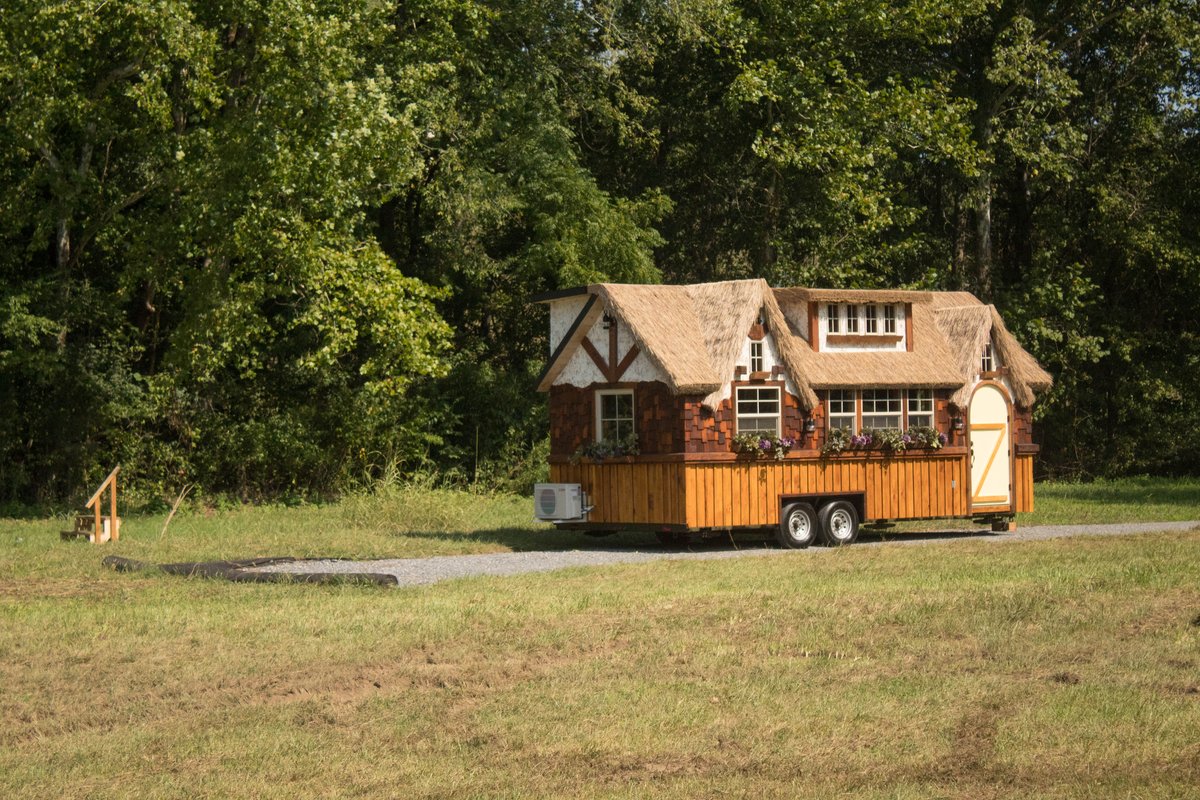 12-Exterior-View-The-Highland-Tiny-Home-on-wheels-with-Thatched-Roof-www-designstack-co