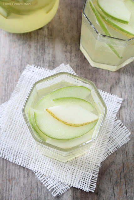 This Apple and Pear White Sangria is the PERFECT drink for fall! Sweet, fruity, and very refreshing! LoveGrowsWild.com