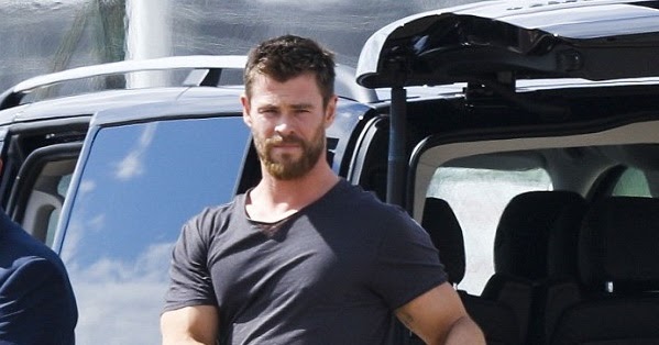 Chris Hemsworth Stretches After Stepping Off A Plane