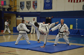 Martial arts black belts competing at a taekwondo tournament