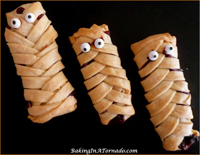 Individual Mummy Pies: Chocolate raspberry hand held pies. Add "eyes" for Halloween mummies. Perfect party snacks. | Recipe developed by www.BakingInATornado.com | #recipe #pie #Halloween