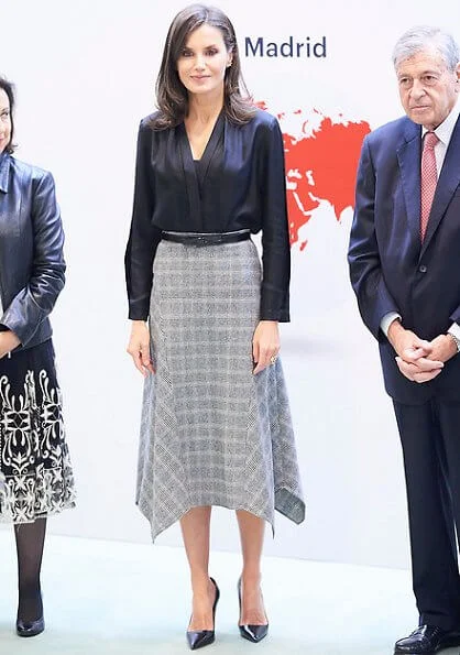 Queen Letizia wore a pointed-check wool skirt by Massimo Dutti and Prada leather pumps and she carried Hugo Boss leather bag